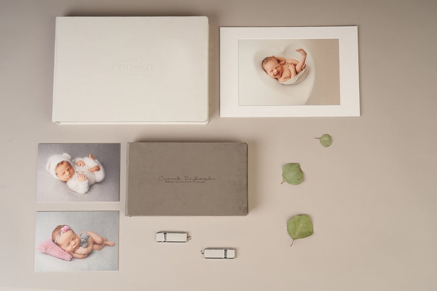 Newborn photography printed on matted prints next to Folio Boxes