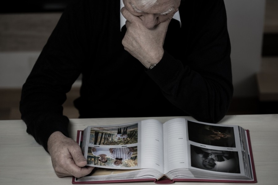 Lonely elderly man recollect happy memories from his life