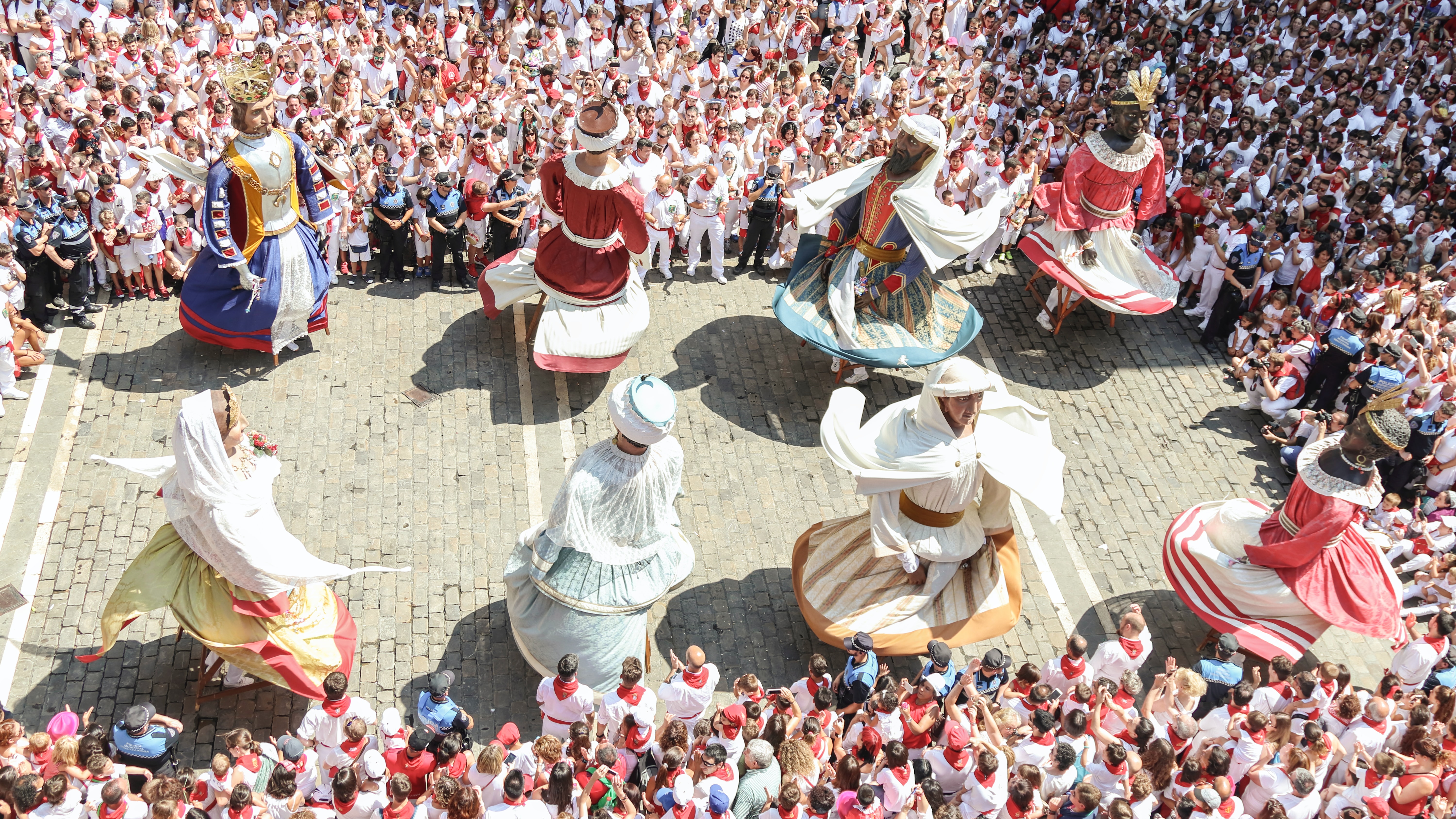 Giant dolls dancing with spectators in a festival